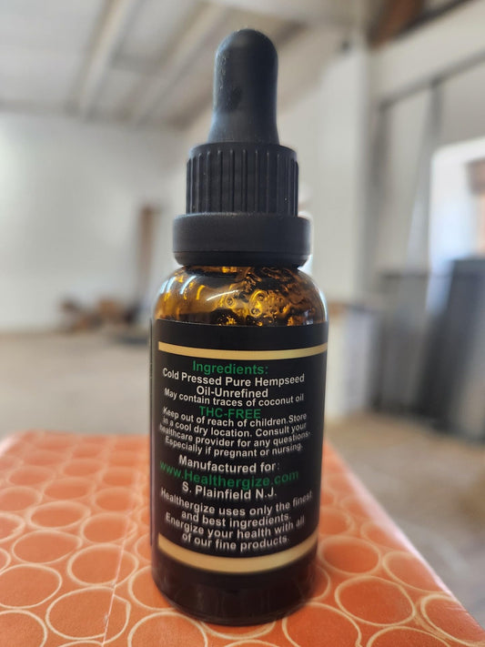 Healthergize hemp oil premium pour showing a slow drizzle for calm evenings.