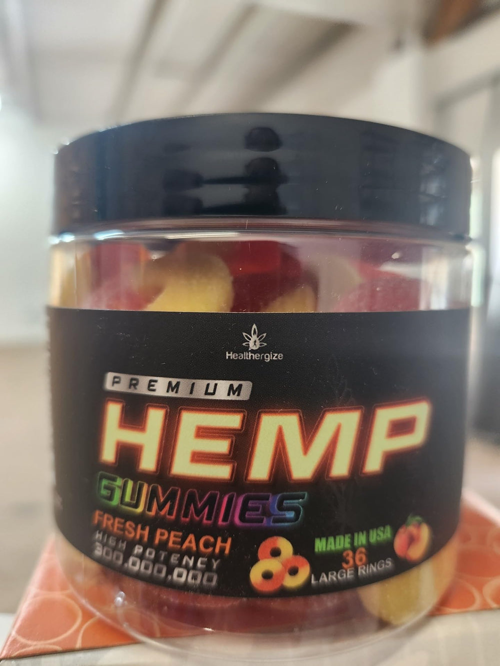 Healthergize Peach Ring Gummies with glass of water for daily calm