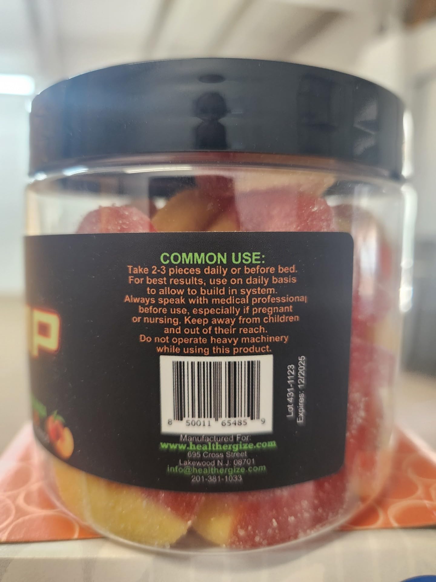 Healthergize Peach Ring Gummies serving on desk, discreet wellness
