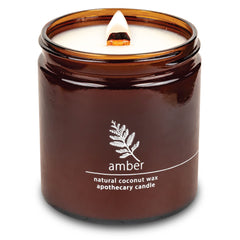 Hemlock Park crackling wood wick candle in amber jar for cozy ambiance.