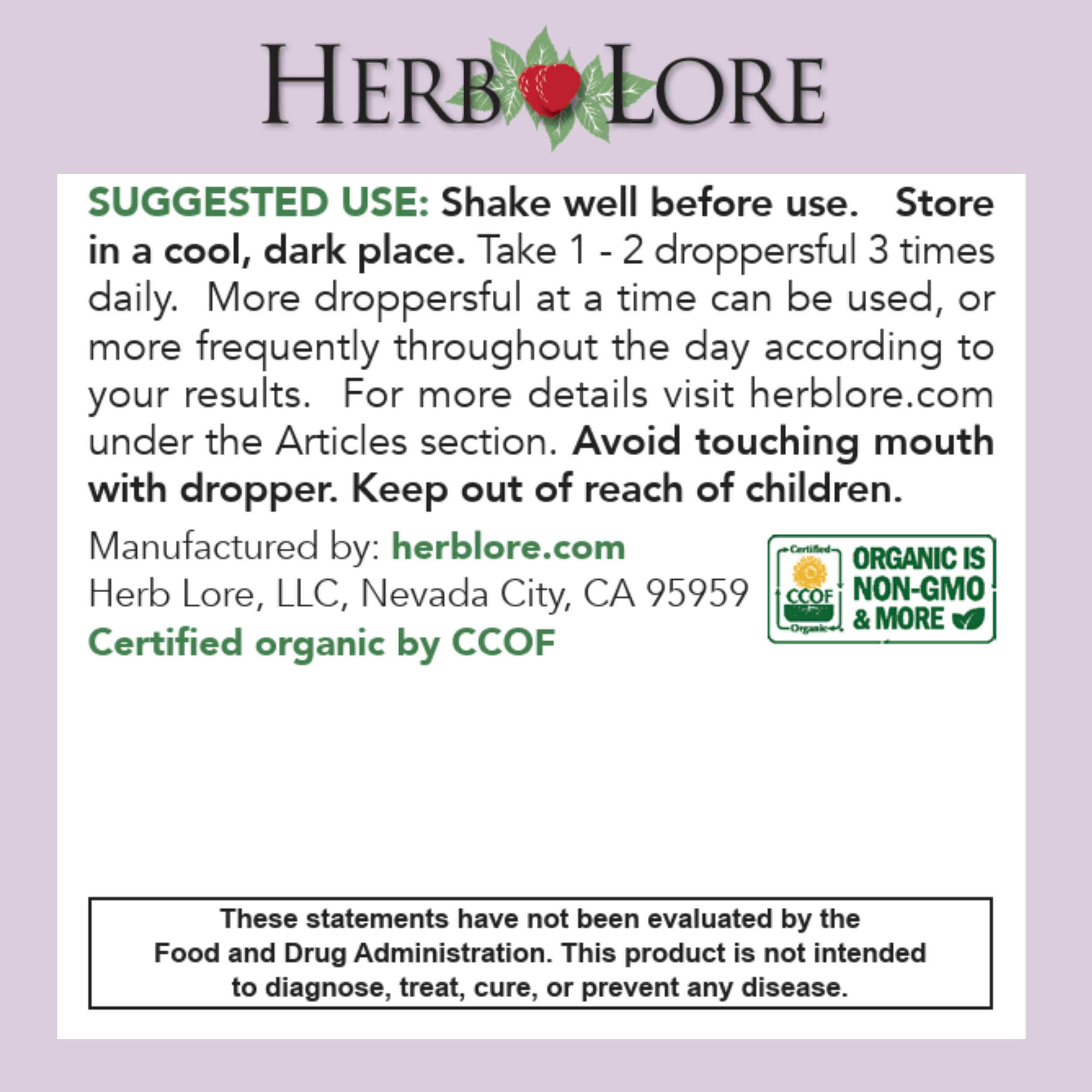 Hand holding dropper releasing tincture into a glass for easy dosing with Herb Lore.