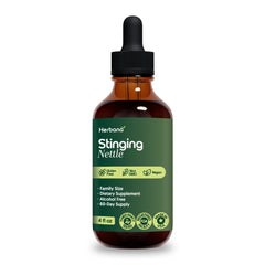 HERBANA nettle tincture droplets in glass illustrate measured dosage.