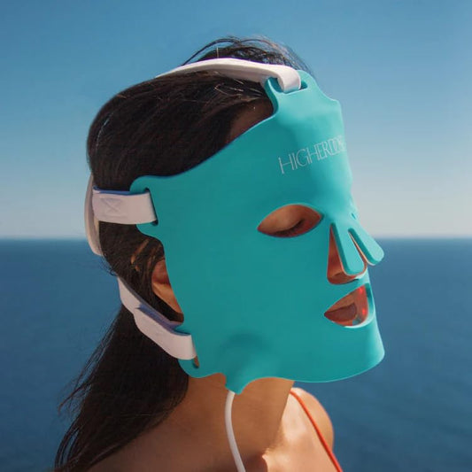 HigherDOSE LED therapy mask close-up showing facial light treatment.