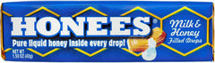 Close-up of Honees drops with creamy milk coating and honey center visible.