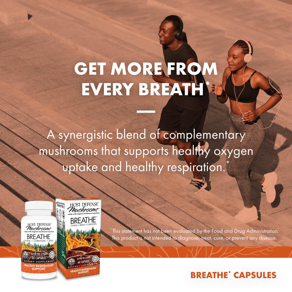 Host Defense Breathe capsules in hand illustrate convenient daily dosage.
