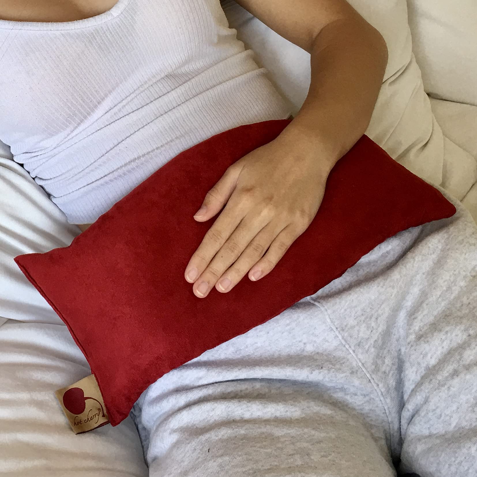 Hot Cherry cervical pillow front view with plush red ultra suede cover for neck comfort.