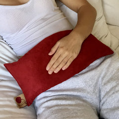 Hot Cherry cervical pillow front view with plush red ultra suede cover for neck comfort.