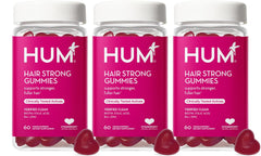 HUM Hair Strong daily gummies bottle for convenient growth support.