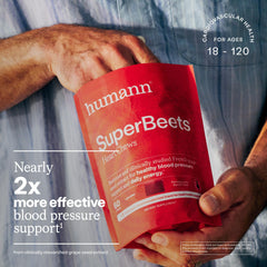 Hands holding Humann SuperBeets Heart Chews ready for convenient on-the-go support.