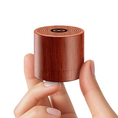 Hushing portable mini white noise machine on a nightstand creates a calm sleep environment.