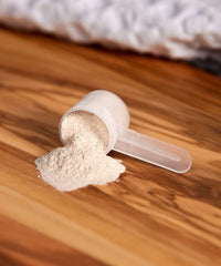 Close-up of powder and scoop beside a smoothie, neutral formula supports daily heart health.