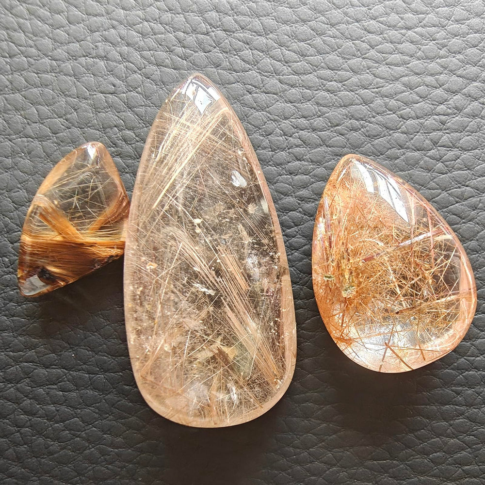 JDFlying rutilated quartz jewelry material sample highlighting dramatic inclusions.