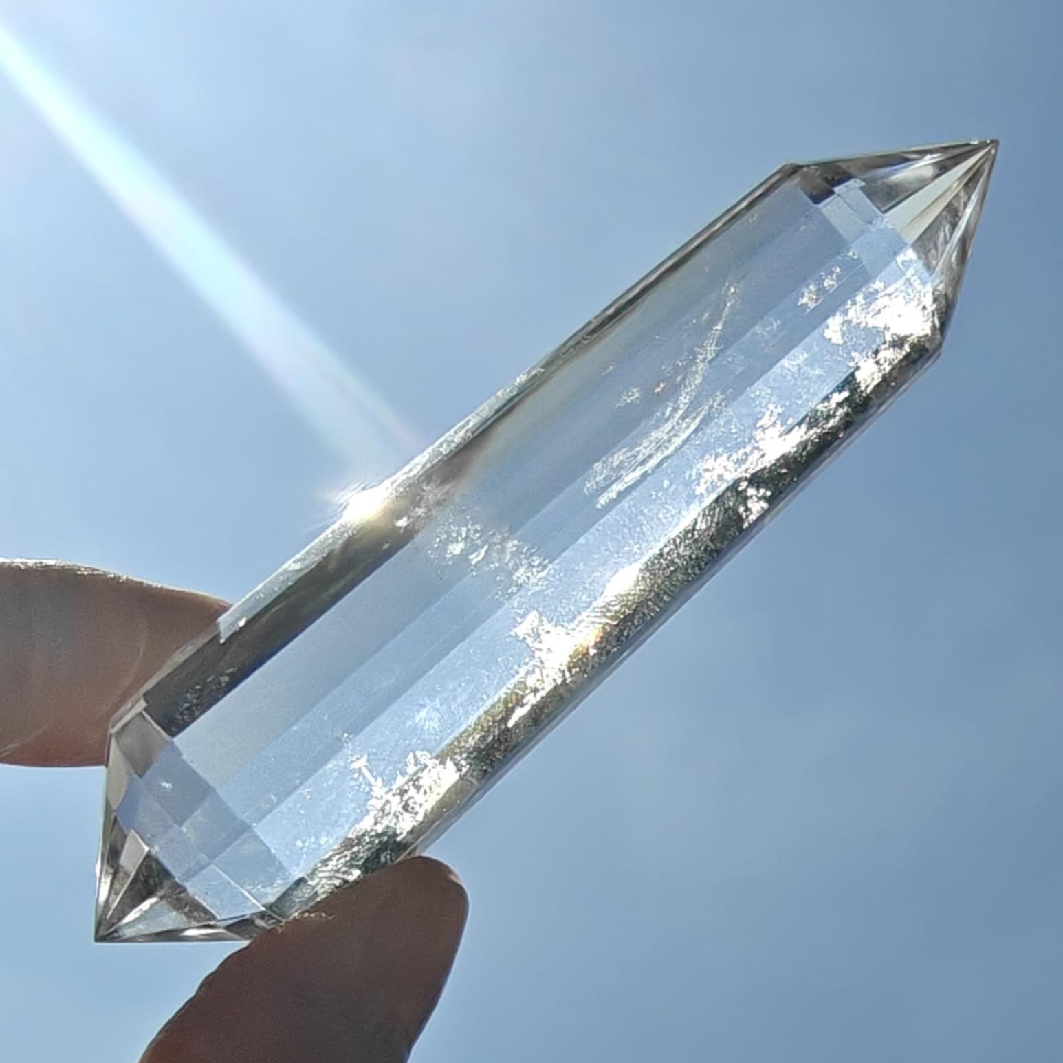 JDFlying Vogel crystal wand 90mm resting on an altar for energy alignment.