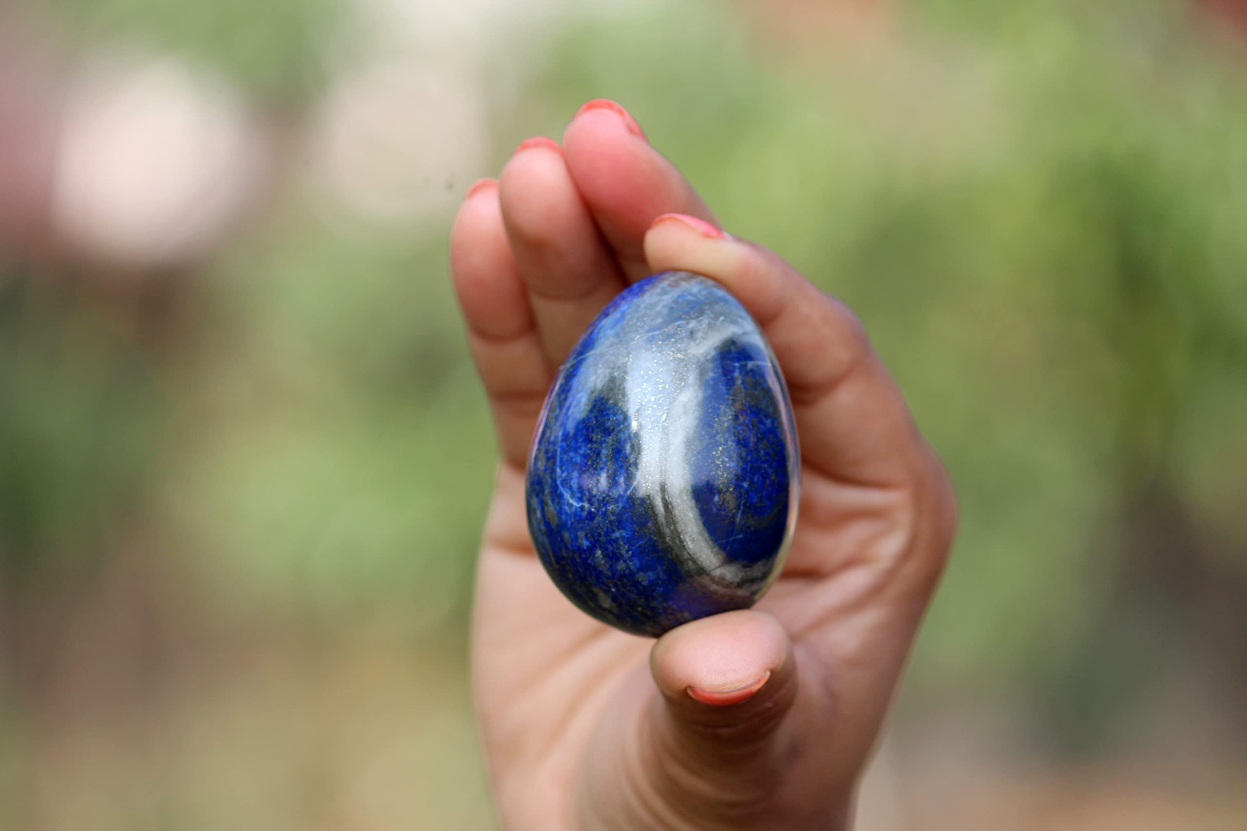Close-up of Jet International Lapis Lazuli egg showing golden pyrite inclusions for inspiration.