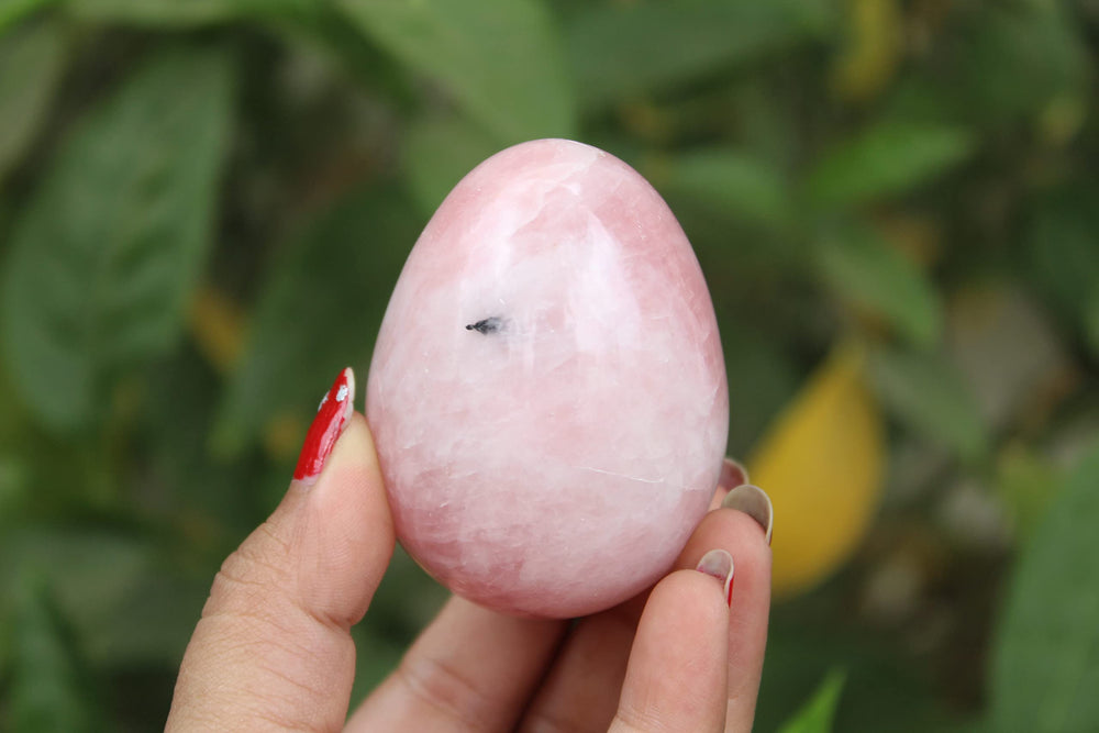 Jet International rose quartz egg close-up shows pink crystal energy.