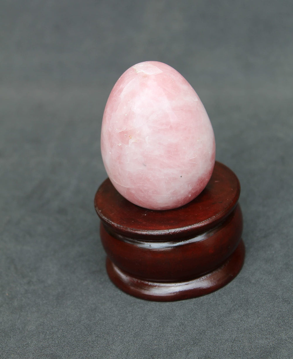 Jet International rose quartz egg on desk creates soft, positive energy.