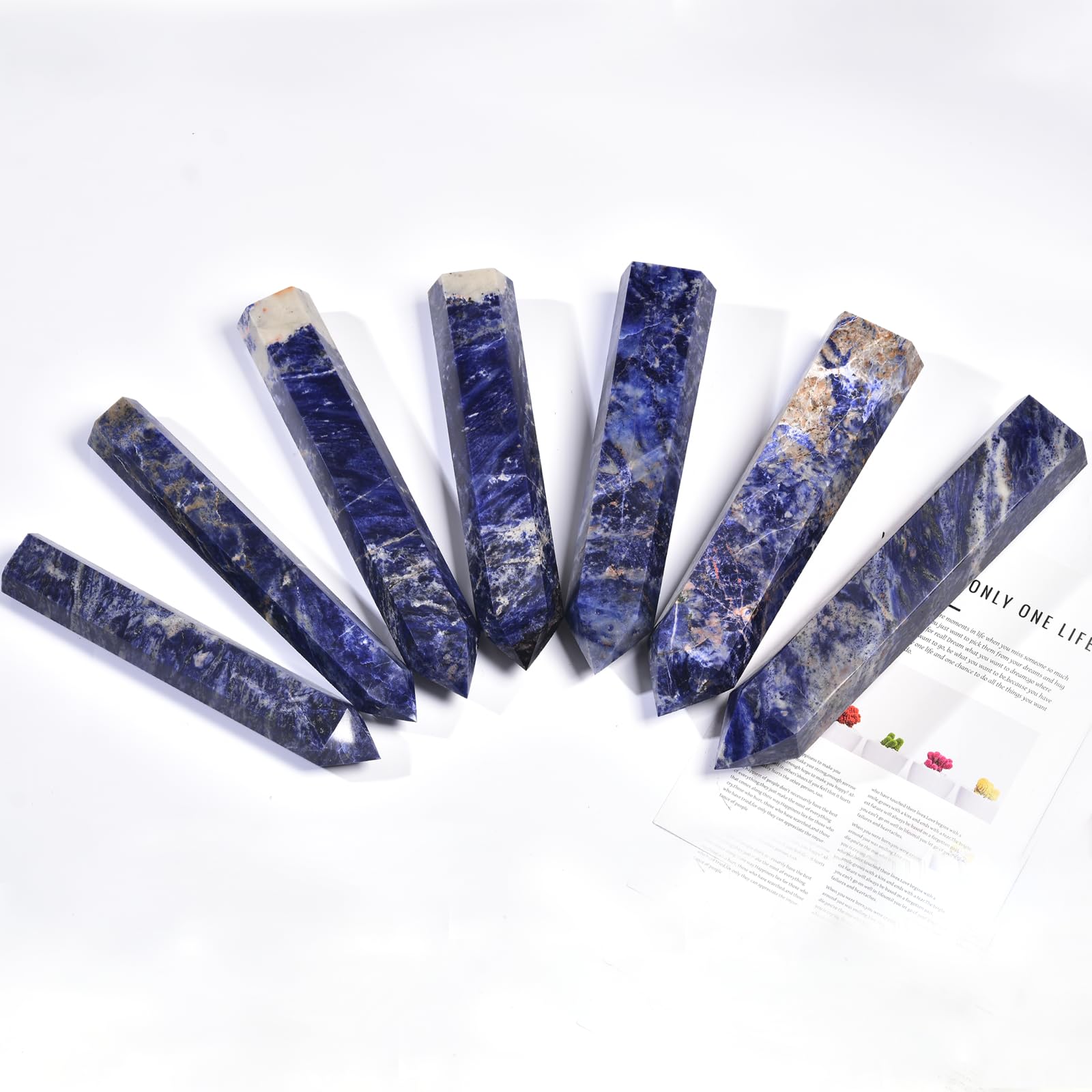 JIC Gem blue sodalite wand in a calming setting for contemplative balance.