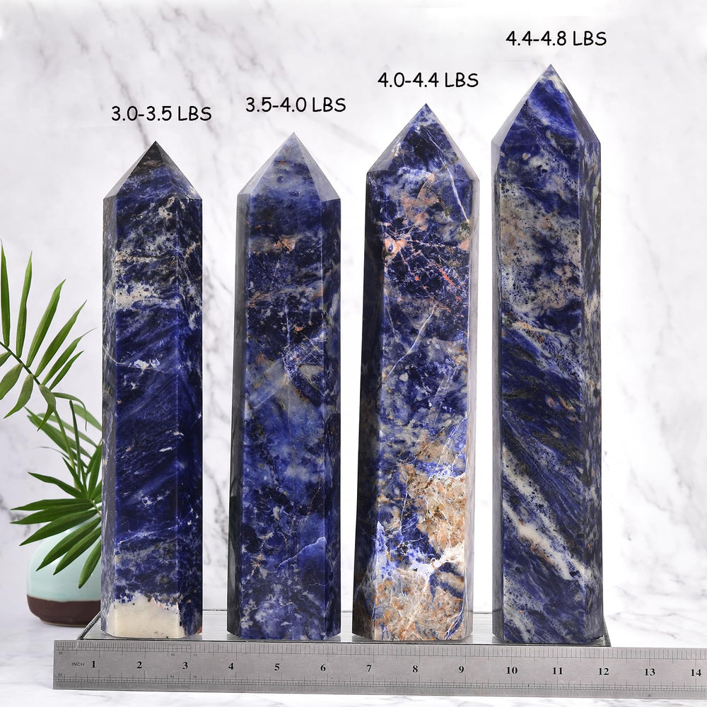 JIC Gem blue sodalite wand on table showcasing size and craftsmanship for energy work.