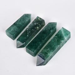 JIC Gem Green Fluorite obelisk tower displayed with a grid and candles