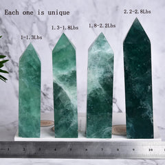 JIC Gem Green Fluorite obelisk wand near a plant and journal for mindfulness