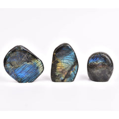 JIC Gem Labradorite palm stone sits on desk to boost energy balance.