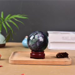 Natural fluorite sphere by JIC Gem enhances mood and decor in living spaces.