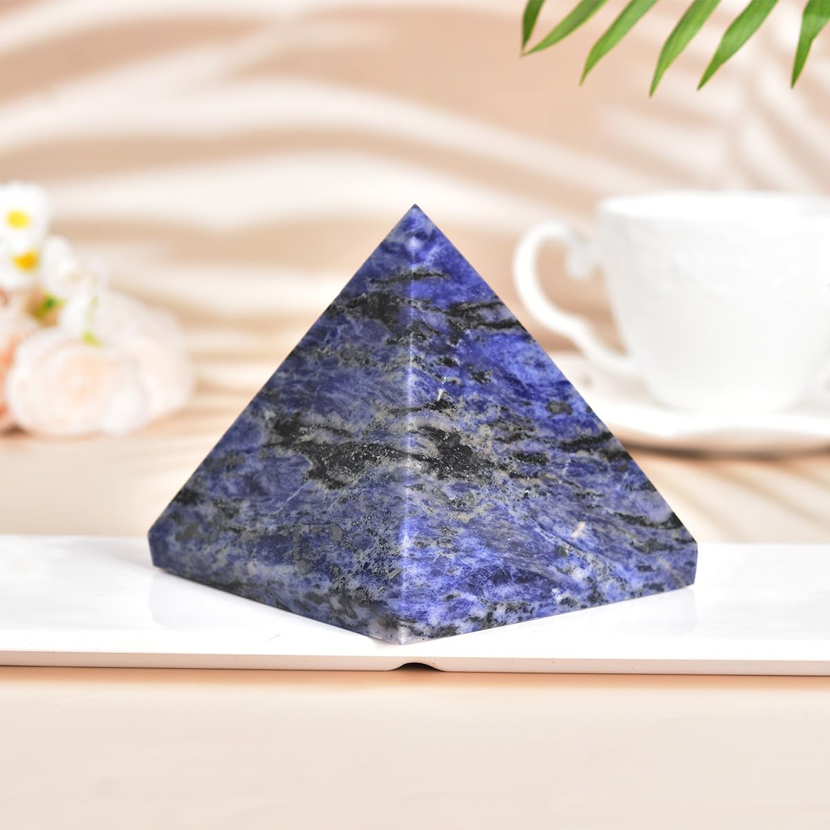 JIC Gem sodalite pyramid on bookshelf creates a positive vibe.