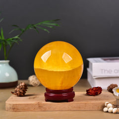JIC Gem yellow fluorite sphere on stand used as a desktop display centerpiece.