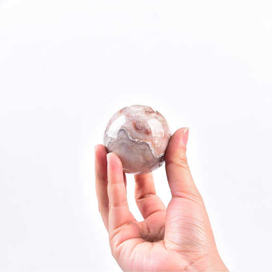JIC Gem pink agate sphere glows softly, enhancing focus during meditation.