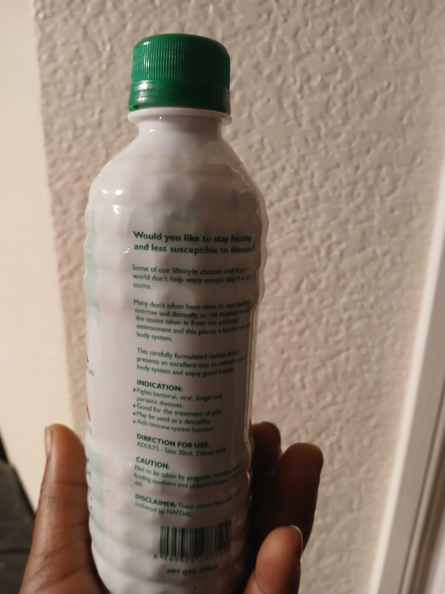 Pouring Jinja Herbal Extract into a glass with a crisp herbal aroma