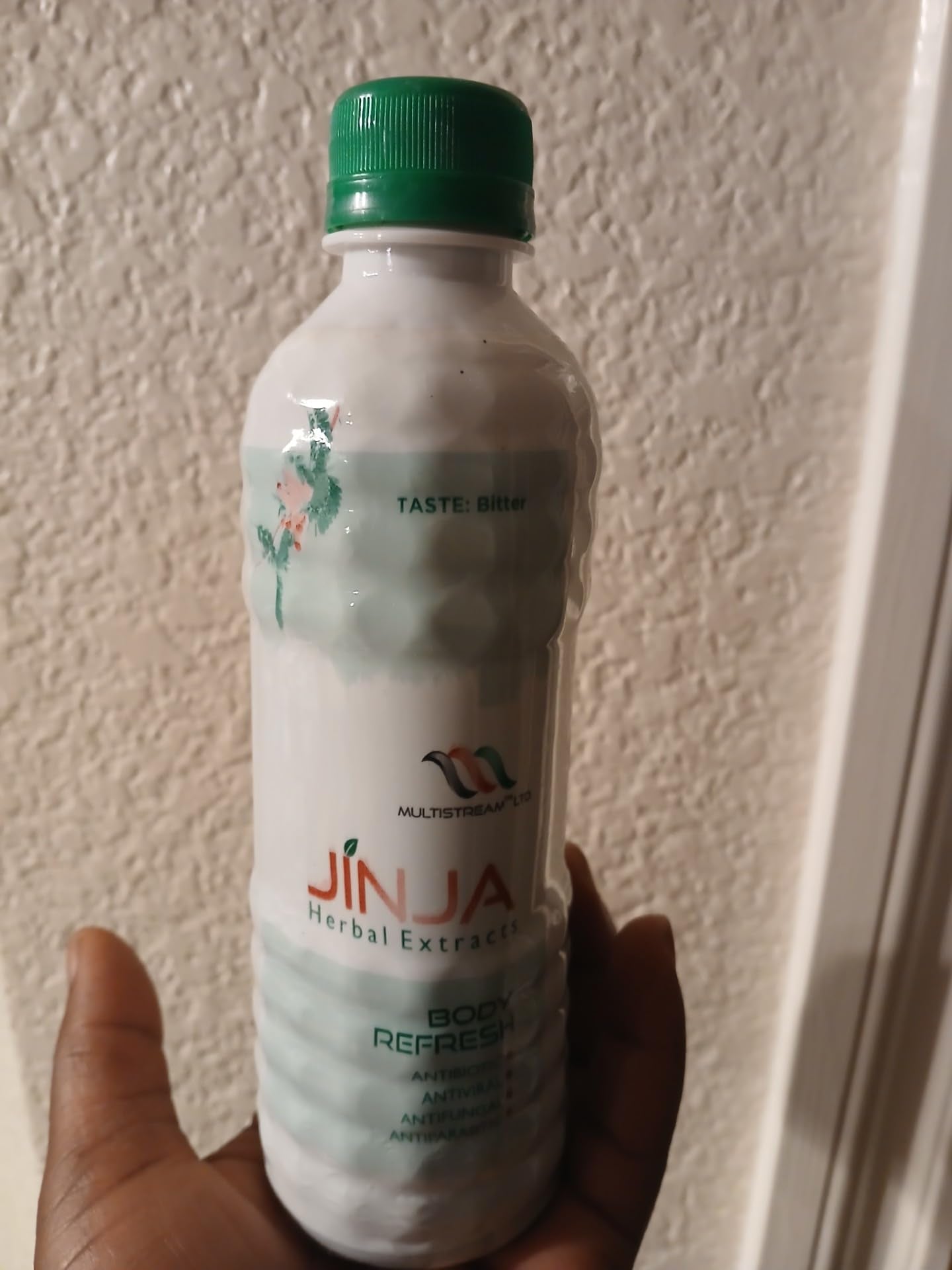Closeup of Jinja Herbal Extract label highlighting natural ingredients