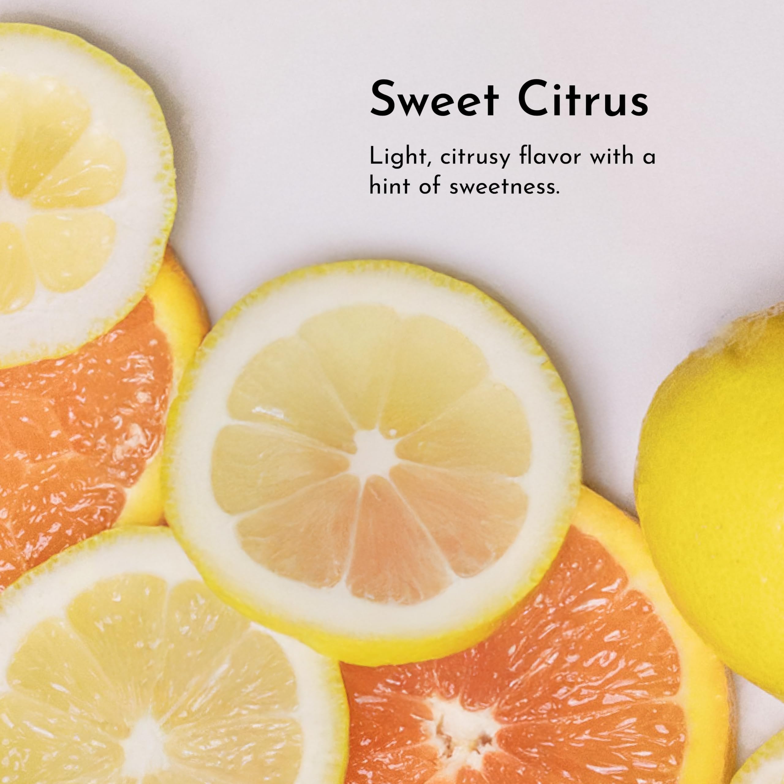 Glass of citrus mouthwash on sink shows alcohol-free formula for gentle daily rinse.