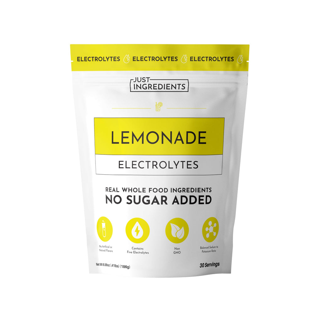 JUST INGREDIENTS Lemonade Electrolytes powder dissolving in water for quick hydration.