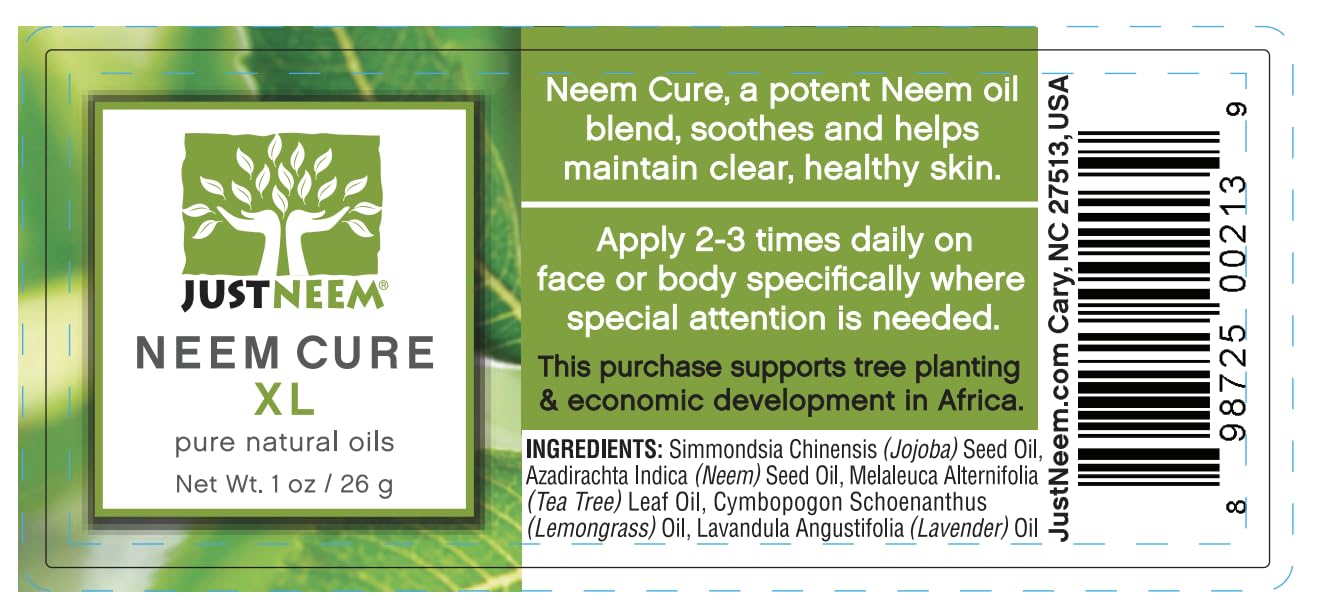 JustNeem Neem Cure Oil XL bottle on a skincare setup highlighting natural oils blend.
