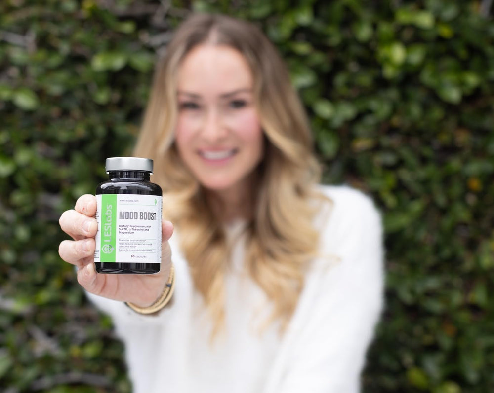 LES Labs Mood Boost in-use glass with capsules for evening relaxation.
