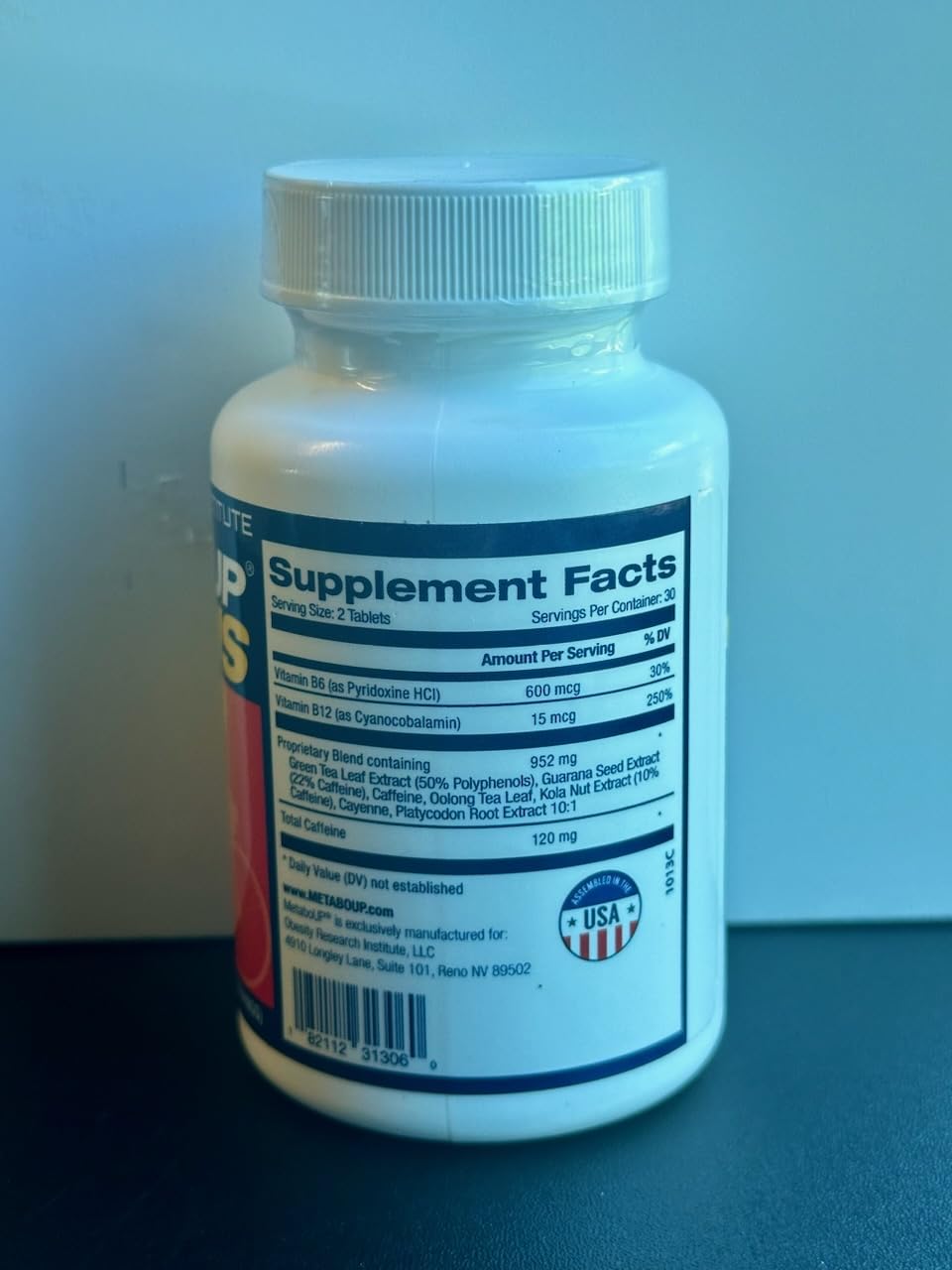 Lipozene MetaboUP Plus bottle in daily-use setting implies routine integration.