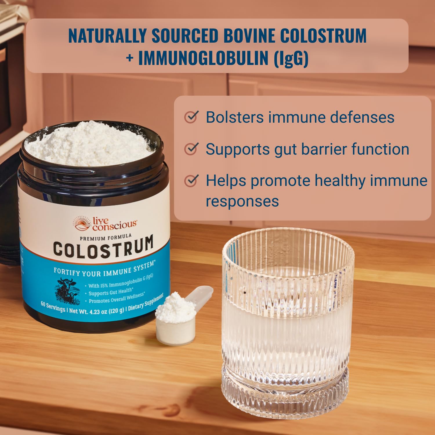 Live Conscious Colostrum powder scoop beside water for easy daily mix.