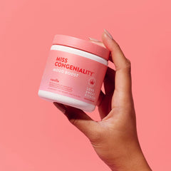 Love Sweat Fitness Mood Boost Powder bottle closeup emphasizes vegan, gluten-free formula.
