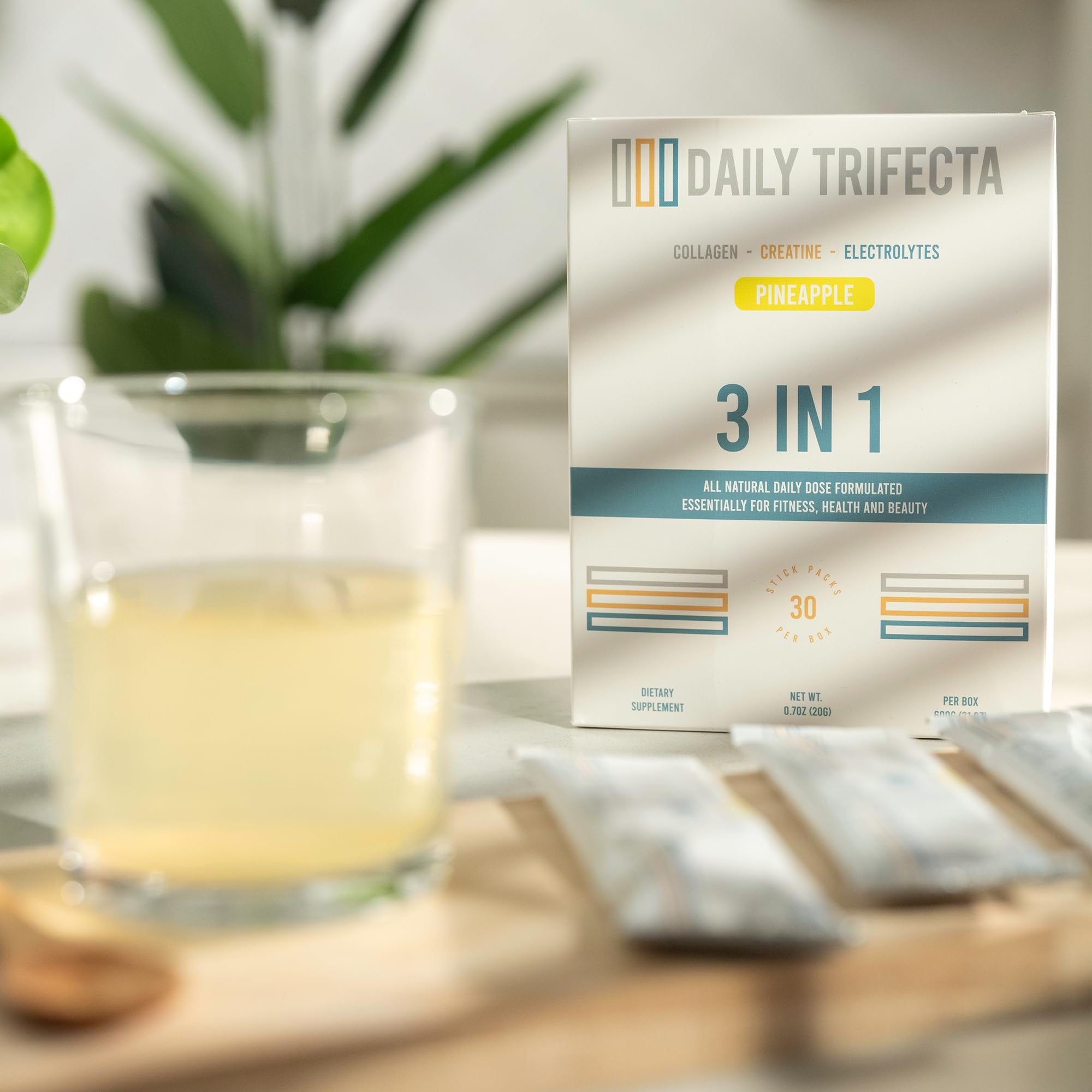 Lovie Style pineapple electrolyte packets shown beside glass of water