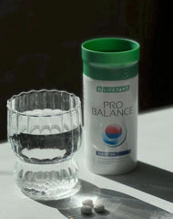 Lifetakt Pro Balance tablets being poured into a glass suggests easy daily use