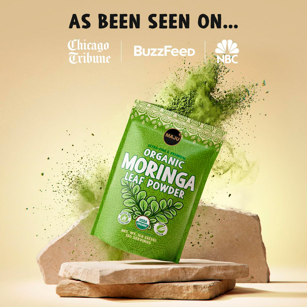Spoon of MAJU moringa powder on breakfast bowl.