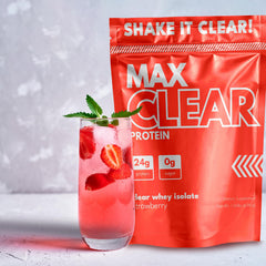 Scoop of Max Clear Protein powder beside glass designed for quick absorption