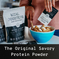 Meal Boosters Savory White Cheddar protein powder scoop for quick measuring.