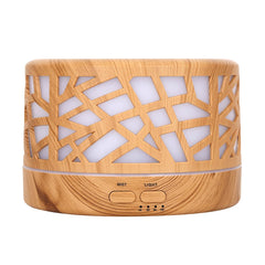mEssentials Wild Essentials diffuser with wood branches design enhances ambient decor while diffusing oils.