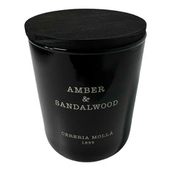Molla 1899 handmade candle close-up showing amber and sandalwood notes for a warm ambiance.