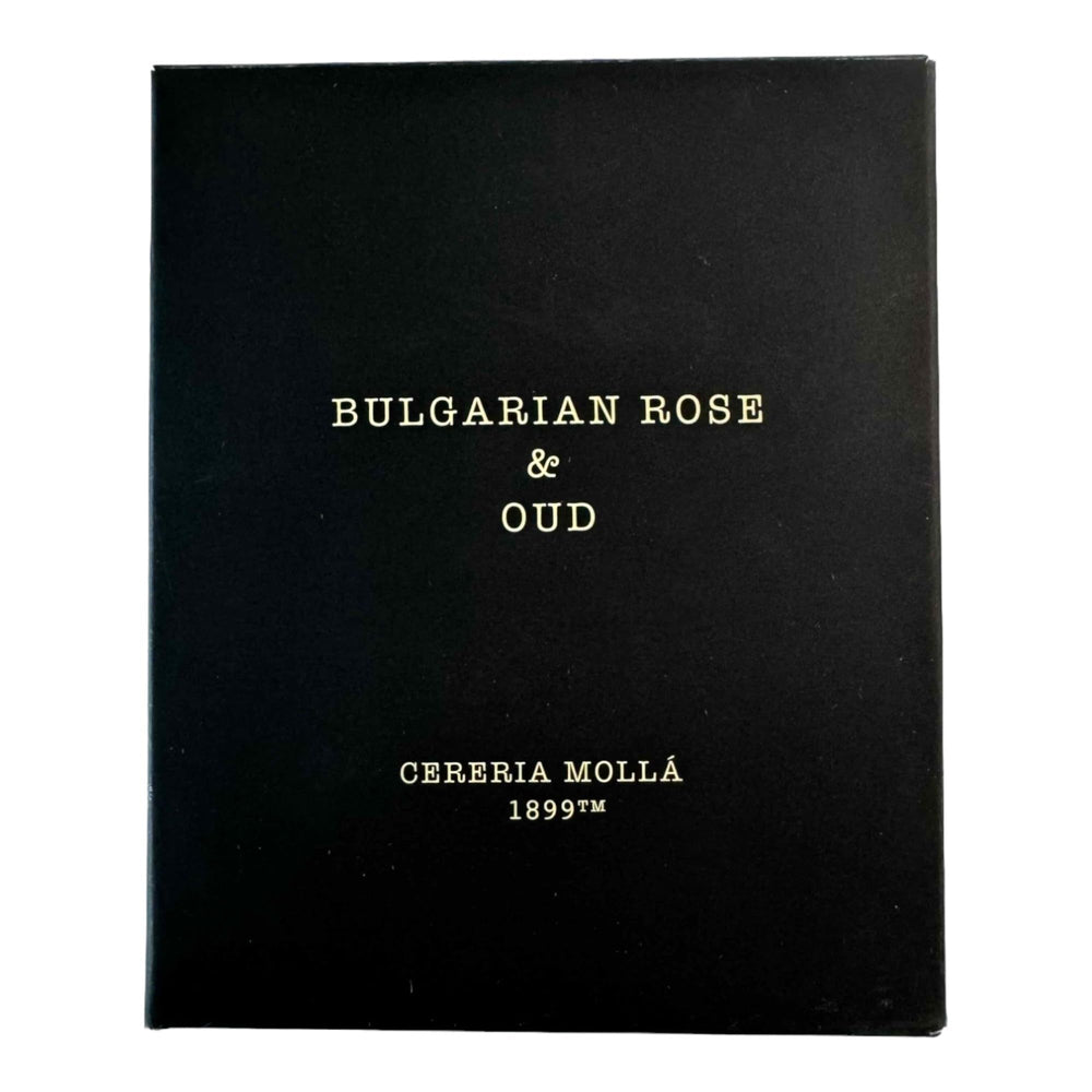 Molla 1899 Bulgarian Rose & Oud candle lit, releasing floral notes to uplift spaces.