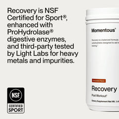 Momentous Recovery whey scoop beside bottle for easy portioning.