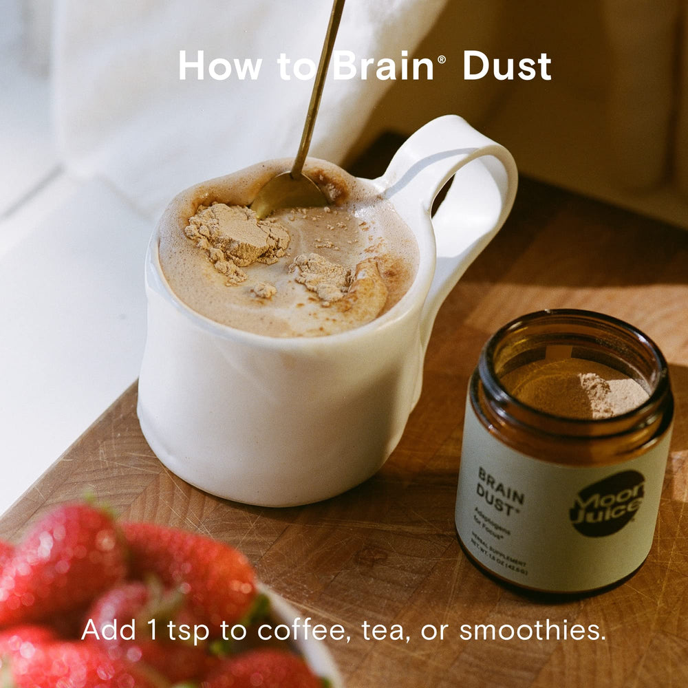 Moon Juice Brain Dust packaging beside a meditation setup for mental stamina.