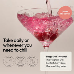 Moon Juice Magnesi-Om powder in a glass with berry garnish.