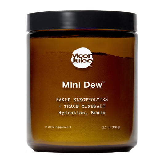 Moon Juice Mini Dew electrolyte powder jar close-up highlighting minerals for hydration.